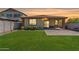 Green backyard featuring a covered patio, lush lawn, and privacy fence, perfect for outdoor enjoyment at 25424 S 224Th Pl, Queen Creek, AZ 85142