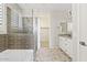 Bright bathroom featuring dual vanity, step-in shower with a tub, and a walk-in closet at 25424 S 224Th Pl, Queen Creek, AZ 85142
