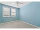 Cozy bedroom featuring carpet flooring, bright blue walls, and plantation shutters at 25424 S 224Th Pl, Queen Creek, AZ 85142