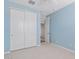 Bedroom with a closet, carpet flooring, bright blue walls, and plantation shutters at 25424 S 224Th Pl, Queen Creek, AZ 85142