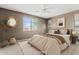 Comfortable bedroom featuring a large window, neutral color scheme, and decorative wall art at 25424 S 224Th Pl, Queen Creek, AZ 85142