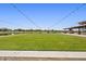 Community green space featuring a lawn, walking paths, lake and outdoor seating at 25424 S 224Th Pl, Queen Creek, AZ 85142