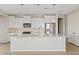 Bright kitchen features white cabinetry, stainless steel appliances, stone backsplash and an oversized island at 25424 S 224Th Pl, Queen Creek, AZ 85142