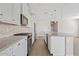 Bright kitchen features white cabinetry, stainless steel appliances, stone backsplash and an oversized island at 25424 S 224Th Pl, Queen Creek, AZ 85142