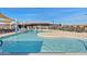 Community pool with lounge area and covered seating offers a refreshing escape for residents at 25424 S 224Th Pl, Queen Creek, AZ 85142