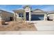 Charming single-story home featuring desert landscaping and a two-car garage, creating a welcoming curb appeal at 25431 W Graham Trl, Buckeye, AZ 85326