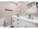 Bathroom featuring double sinks, white cabinets, modern fixtures, and a neutral color palette at 3315 W Shaw Butte Dr, Phoenix, AZ 85029