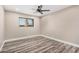 Neutral bedroom featuring window with blinds and wood-look laminate flooring at 3315 W Shaw Butte Dr, Phoenix, AZ 85029