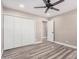 Clean bedroom featuring ceiling fan, closet space and an open door at 3315 W Shaw Butte Dr, Phoenix, AZ 85029