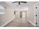 Spacious bedroom with new flooring, modern ceiling fan, natural light, and a sliding barn door closet at 3315 W Shaw Butte Dr, Phoenix, AZ 85029