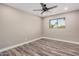 Bedroom with a window and wood-look laminate flooring and neutral paint at 3315 W Shaw Butte Dr, Phoenix, AZ 85029