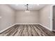 Dining room with wood flooring, neutral colors, and a modern chandelier at 3315 W Shaw Butte Dr, Phoenix, AZ 85029