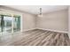 Well-lit dining area featuring wood floors and sliding doors to the outdoor space at 3315 W Shaw Butte Dr, Phoenix, AZ 85029