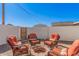 A brick firepit area is surrounded by four orange woven chairs at 3315 W Shaw Butte Dr, Phoenix, AZ 85029