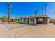 Exterior view of a well-maintained home with palm trees, featuring a neat gravel front yard at 3315 W Shaw Butte Dr, Phoenix, AZ 85029
