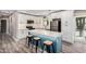Modern kitchen with stainless steel appliances, white cabinetry, and a blue kitchen island at 3315 W Shaw Butte Dr, Phoenix, AZ 85029