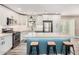 Bright kitchen features white cabinets, stainless steel appliances, island with seating, and modern finishes at 3315 W Shaw Butte Dr, Phoenix, AZ 85029