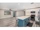 Open floor plan showcases a renovated kitchen with island seating and spacious living area with modern design at 3315 W Shaw Butte Dr, Phoenix, AZ 85029