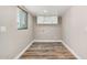 Bright laundry room showcasing window, white cabinets and wood-look flooring at 3315 W Shaw Butte Dr, Phoenix, AZ 85029