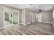 Bright living room features new flooring, a modern ceiling fan, and sliding doors to the backyard at 3315 W Shaw Butte Dr, Phoenix, AZ 85029