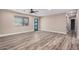 Spacious living room with wood-look flooring, neutral decor, and a stylish front door at 3315 W Shaw Butte Dr, Phoenix, AZ 85029