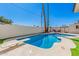 Backyard pool area surrounded by palm trees, a diving board and concrete patio at 3315 W Shaw Butte Dr, Phoenix, AZ 85029