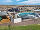 Aerial view showcasing a large pool, splashpad, playground, and surrounding homes with a mountain backdrop at 3513 E Audrey Dr, San Tan Valley, AZ 85143