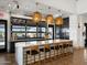 Chic kitchen bar with marble counters, pendant lights, and a view of outdoor amenities through a large window at 3513 E Audrey Dr, San Tan Valley, AZ 85143