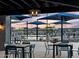Charming patio area with tables, chairs, and umbrellas, creating a relaxing space for outdoor dining and socializing at 3513 E Audrey Dr, San Tan Valley, AZ 85143