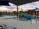 Inviting pool area with a splash pad and clubhouse, creating a fun and refreshing community space at 3513 E Audrey Dr, San Tan Valley, AZ 85143