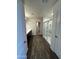 Bathroom with sleek wood flooring, glass shower, and double sink vanity with walk in closet at 36992 W Capri Ave, Maricopa, AZ 85138
