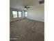 Expansive bedroom with multiple windows offering ample natural light and neutral carpeting at 36992 W Capri Ave, Maricopa, AZ 85138