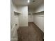 Walk-in closet with carpet flooring and wall-mounted shelving for ample storage at 36992 W Capri Ave, Maricopa, AZ 85138