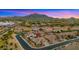 Aerial view showcasing a well-maintained home and landscaped neighborhood with mountain views at 3953 E Lafayette Ave, Gilbert, AZ 85298