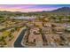 Wide aerial shot of neighborhood with desert landscaping, community shopping and beautiful mountain views at 3953 E Lafayette Ave, Gilbert, AZ 85298