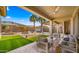 Beautiful backyard featuring a covered patio, artificial turf, and a sparkling pool with a water feature at 3953 E Lafayette Ave, Gilbert, AZ 85298