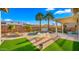 Resort style backyard with heated pool, a spa, and lush artificial turf, perfect for outdoor living and entertaining at 3953 E Lafayette Ave, Gilbert, AZ 85298
