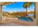 Stunning backyard showcasing a sparkling pool with a water feature, lush landscaping, and a covered patio area at 3953 E Lafayette Ave, Gilbert, AZ 85298