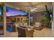 Relaxing covered patio featuring stylish wicker furniture, perfect for entertaining and enjoying the backyard view at 3953 E Lafayette Ave, Gilbert, AZ 85298