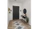 Modern home entryway with decorative rug, a dark door, and sleek console table at 3953 E Lafayette Ave, Gilbert, AZ 85298