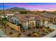 Exterior view featuring a home with manicured landscape and a three-car garage at 3953 E Lafayette Ave, Gilbert, AZ 85298