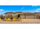 Beautiful single-Gathering home featuring desert landscaping, a stone accents, and a three-car garage at 3953 E Lafayette Ave, Gilbert, AZ 85298