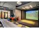 Community center game room features a golf simulator, arcade games, and lounge area at 3953 E Lafayette Ave, Gilbert, AZ 85298
