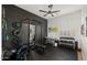 Bright home gym featuring ample workout equipment, ceiling fan, black accent wall and natural lighting at 3953 E Lafayette Ave, Gilbert, AZ 85298