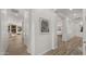 Inviting hallway featuring wood floors, white walls, and art leading to the living area at 3953 E Lafayette Ave, Gilbert, AZ 85298