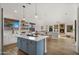 Bright, open-concept kitchen with modern island, eat-in dining and decorative shelving at 3953 E Lafayette Ave, Gilbert, AZ 85298