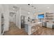 Bright open kitchen with white cabinets, stainless appliances, pendant lighting, and dining area seating at 3953 E Lafayette Ave, Gilbert, AZ 85298