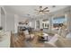 Bright open-concept living room with wood floors, fireplace, modern furniture, and large windows showcasing the backyard at 3953 E Lafayette Ave, Gilbert, AZ 85298