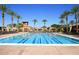 Large swimming pool with lap lanes and surrounding palm trees at the community center at 3953 E Lafayette Ave, Gilbert, AZ 85298