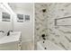 Modern bathroom featuring stylish geometric tiles, tub, black fixtures, and a bright vanity at 4410 N 20Th Ave, Phoenix, AZ 85015